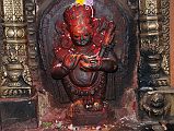 Kathmandu Patan Golden Temple 03 Mahakala In Entrance Doorway Mahakala, a deity worshipped by both Buddhists and Hindus, defends the dharma at the entrance to the Golden temple in Patan. Mahakala is of the eight terrible deities of the Buddhist pantheon, with snake ornaments, sharp teeth, protruding belly, and wearing a tiger skin.